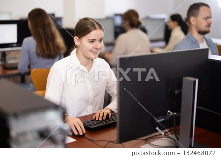 Female student at computers in university computer class Female student at computers in university computer class 132468072