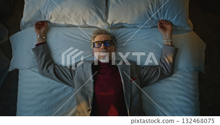 Aged Man in Suit Happily Falls Down on White Bed in Cozy Hotel Room Aged Man in Suit Happily Falls Down on White Bed in Cozy Hotel Room 132468075