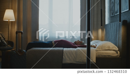 Mature Businessman Enters Stylish Hotel Room After Long Business Trip Mature Businessman Enters Stylish Hotel Room After Long Business Trip 132468310
