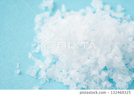 Close-up of coarse salt on a light blue background Close-up of coarse salt on a light blue background 132468325