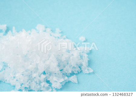 Close-up of coarse salt on a light blue background Close-up of coarse salt on a light blue background 132468327