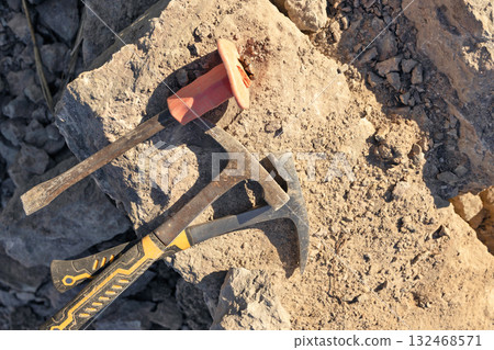 Two hammers and chisel lie on limestone stone Two hammers and chisel lie on limestone stone 132468571