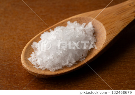 Close-up of coarse salt on a wooden spoon Close-up of coarse salt on a wooden spoon 132468679