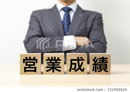 A businessman with his arms crossed and a block that reads "Sales Performance" 132468826