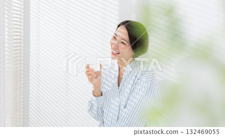 A woman drinking mineral water A woman drinking mineral water 132469055