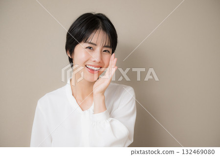 Cute woman in cheering pose on beige background Cute woman in cheering pose on beige background 132469080