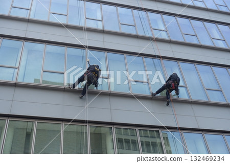 Workers cleaning windows in a high-rise building 132469234