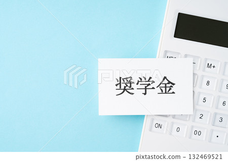Scholarship lettering and calculator on a light blue background 132469521