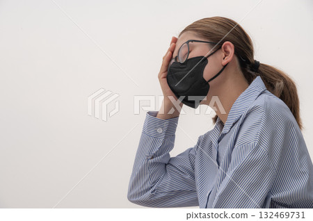 Asian woman having headache becaused of by Bad air pollution (PM2.5). PM2.5 levels meaning the air quality posed a health hazard. Asian woman having headache becaused of by Bad air pollution (PM2.5). PM2.5 levels meaning the air quality posed a health hazard. 132469731