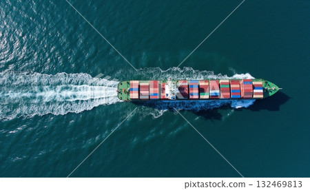 Aerial View of Container Ship Navigating Through Deep Blue Ocean Water 132469813