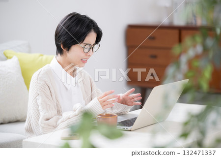 Woman having online meeting on computer, troubled 132471337