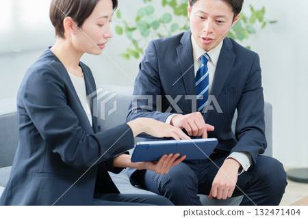 Business people having a meeting using a tablet Business people having a meeting using a tablet 132471404