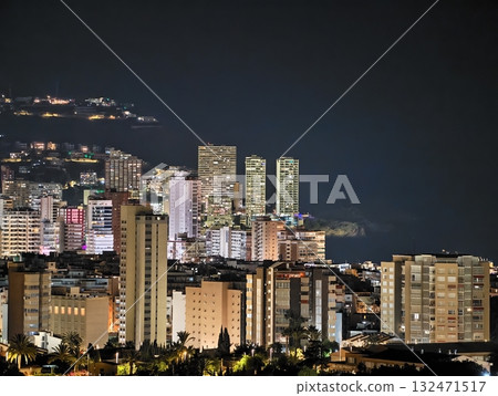 vivid metropolitan landscape featuring densely arranged highrise dwellings aglow with varied neon vivid metropolitan landscape featuring densely arranged highrise dwellings aglow with varied neon 132471517
