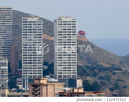 concrete apartment structures with balconies and reflective glass midst natural hillside concrete apartment structures with balconies and reflective glass midst natural hillside 132471522