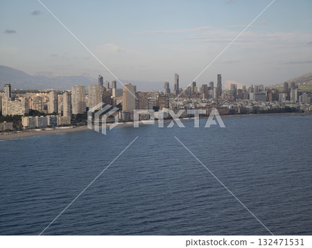 seaside cityscape views, sunlit urban shore with distant mountain backdrop and highrise silhouettes seaside cityscape views, sunlit urban shore with distant mountain backdrop and highrise silhouettes 132471531