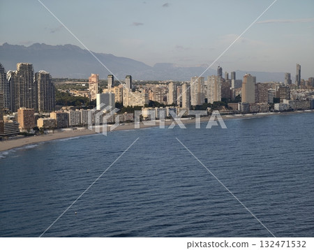 bright coastal scene, luminous seaside skyline featuring textured waters and illuminated tall 132471532