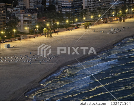 twilight city ocean, landscaped cityscape at dusk, city skyline illuminated along shoreline 132471564