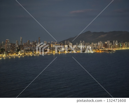 dynamic coastal lights emphasizing lively waterfront area and vibrant nightlife atmosphere dynamic coastal lights emphasizing lively waterfront area and vibrant nightlife atmosphere 132471608