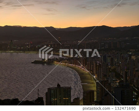 bright shoreline and tranquil ambiance, evening at bay with illuminated walkways and peaceful waters bright shoreline and tranquil ambiance, evening at bay with illuminated walkways and peaceful waters 132471690