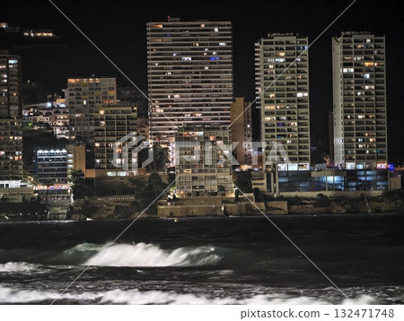 luminous skyline with diverse architecture reflected in tranquil waters during lively nocturnal 132471748