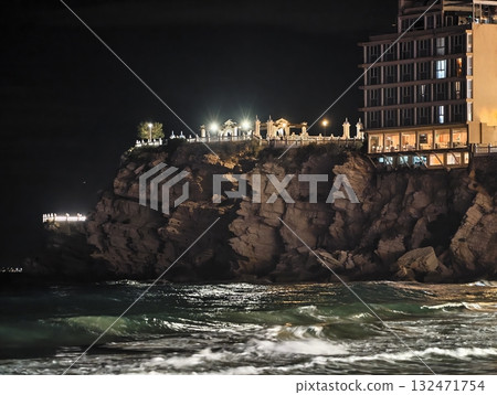 luminous skyline with diverse architecture reflected in tranquil waters during lively nocturnal 132471754