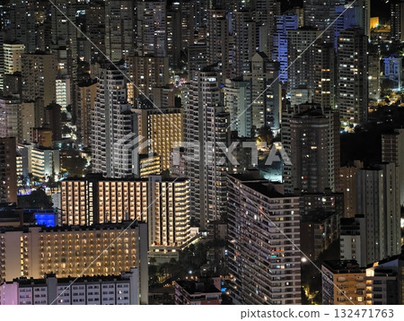 luminous skyline with diverse architecture reflected in tranquil waters during lively nocturnal 132471763