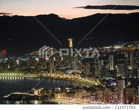 luminous skyline with diverse architecture reflected in tranquil waters during lively nocturnal 132471765