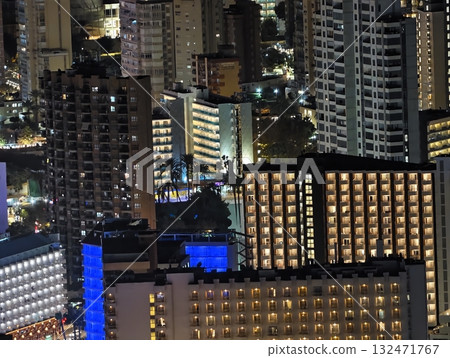 luminous skyline with diverse architecture reflected in tranquil waters during lively nocturnal 132471767