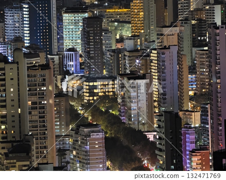 luminous skyline with diverse architecture reflected in tranquil waters during lively nocturnal 132471769