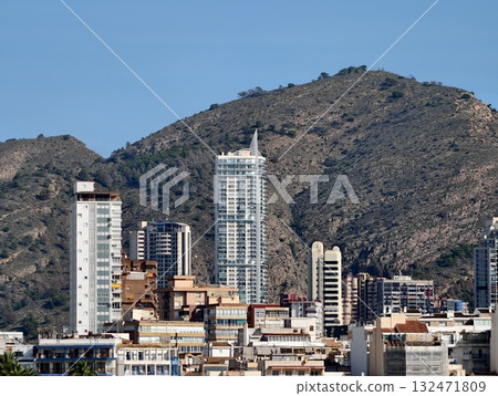 urban landscape transformation, cityscape showing construction against mountains and blue sky urban landscape transformation, cityscape showing construction against mountains and blue sky 132471809