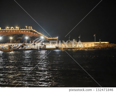 luminous skyline with diverse architecture reflected in tranquil waters during lively nocturnal 132471846