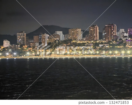 luminous skyline with diverse architecture reflected in tranquil waters during lively nocturnal 132471853