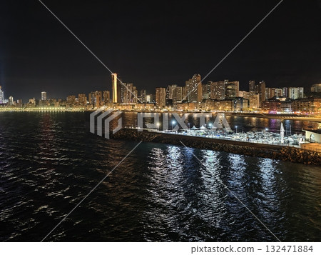 harbor at night, moody maritime setting featuring light trails and shimmering reflections at dusk 132471884