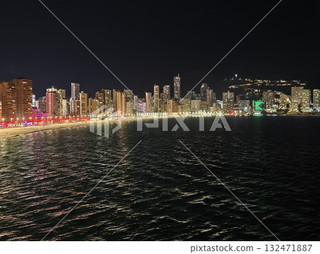 neon cityscape reflections, vibrant neon city lights ripple on dark sea beneath lively urban skyline 132471887