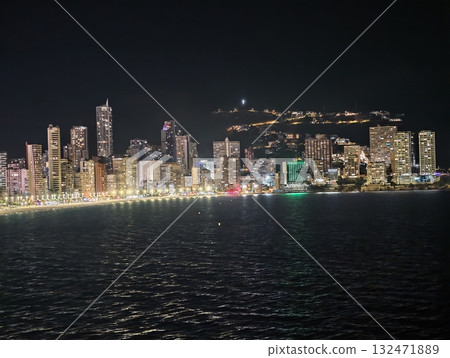 night cityscape view, vast nighttime scene showcasing glowing skyscrapers and rolling ocean waves night cityscape view, vast nighttime scene showcasing glowing skyscrapers and rolling ocean waves 132471889