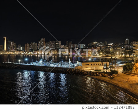 serene waterfront stroll, peaceful promenade overlooking tranquil bay with city lights glowing serene waterfront stroll, peaceful promenade overlooking tranquil bay with city lights glowing 132471892