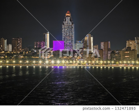 evening skyline highlights, night scene featuring illuminated structures and seaside reflections evening skyline highlights, night scene featuring illuminated structures and seaside reflections 132471893
