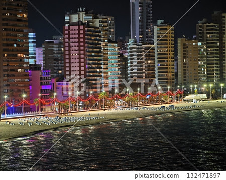vibrant waterfront walkway, colorful street along water with lively illuminated attractions 132471897