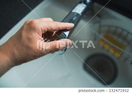 Touch the kitchen tap 132471932