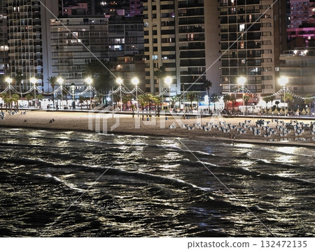 waves dancing under neon glow, reflective wet sand captures vivid neon streaks and gentle wave waves dancing under neon glow, reflective wet sand captures vivid neon streaks and gentle wave 132472135