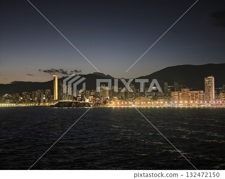 coastal night scene, nighttime coastal landscape featuring luminous skyline and tranquil reflections coastal night scene, nighttime coastal landscape featuring luminous skyline and tranquil reflections 132472150