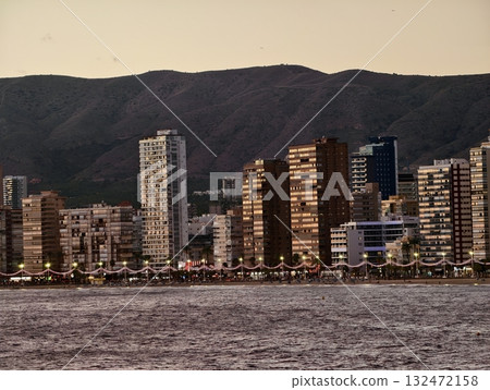 peaceful coastal landscape with radiant sunlight, quiet seaside town bathed in warm evening peaceful coastal landscape with radiant sunlight, quiet seaside town bathed in warm evening 132472158