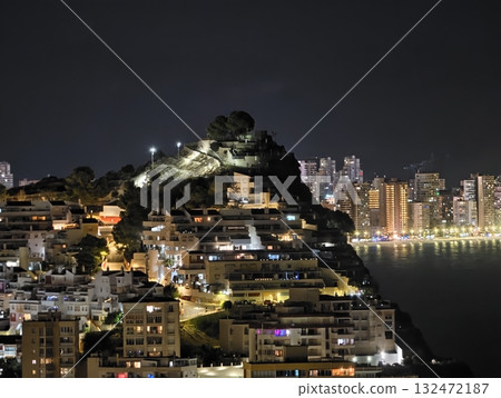 elevated tower overlooking cityscape, mountain sentinel shining above bustling coastal urban area 132472187