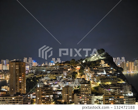 sweeping panoramic vista of bustling coastal city with glowing buildings and reflective waters 132472188