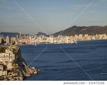 vivid coastal view with sky, radiant seaside cityscape with azure waters and distinct rooftop 132472208