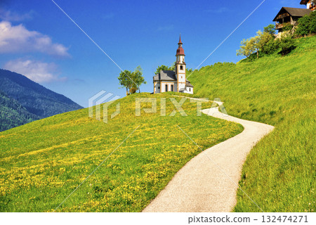 A combination of beautiful European countryside and a European-style church 132474271
