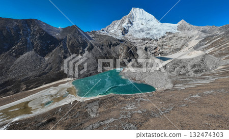 Aerial view of beautiful snow capped mountain and lake landscape in Tibet, China Aerial view of beautiful snow capped mountain and lake landscape in Tibet, China 132474303