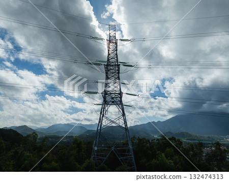 Aerial view of high voltage electricity tower on mountain 132474313