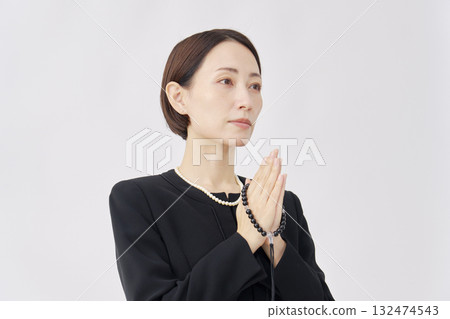 Woman in mourning clothes praying white background 132474543
