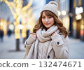 A woman in a winter outfit with beige tones all over her body 132474671